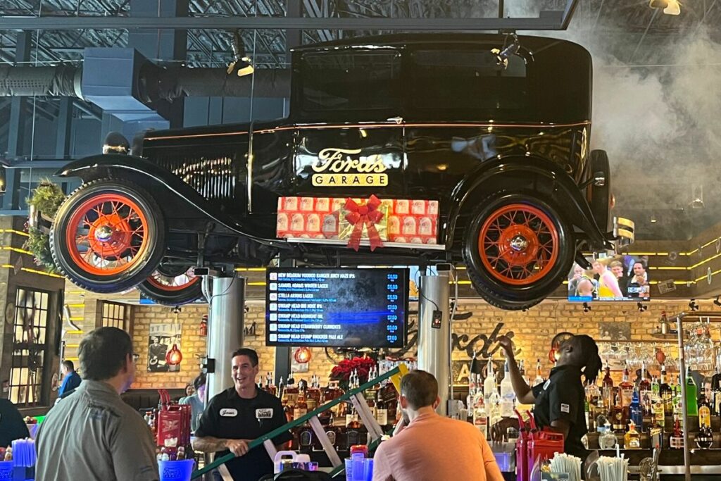 A car hangs over the bar at the new Ford's Garage restaurant.