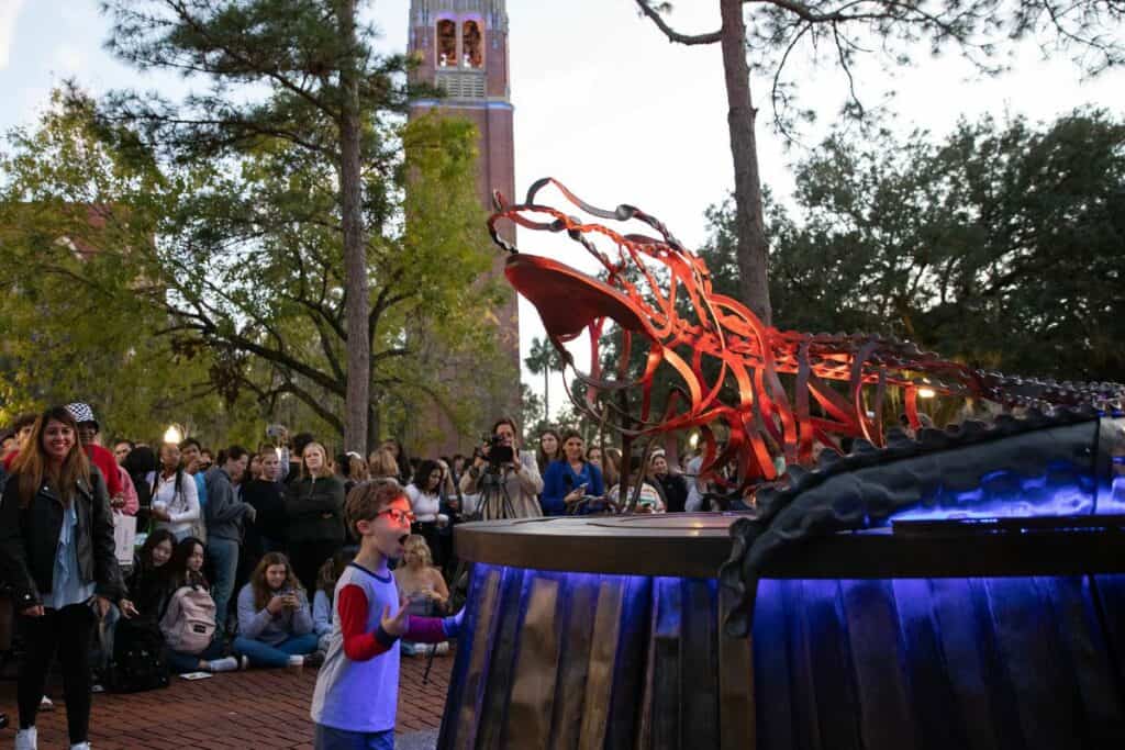 A young attendee marvels at the lights on the gator statue, which was constructed by Gainesville artist and blacksmith Leslie Tharp, a UF alumna.