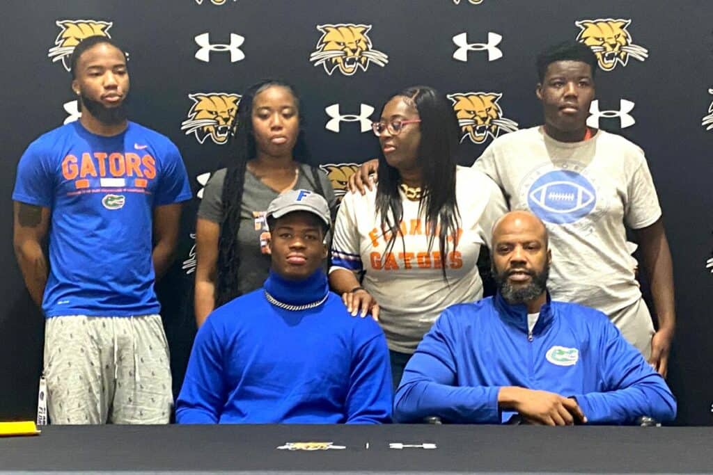 Buchholz's Gavin Hill (front left) committed to play football at Florida on Tuesday
