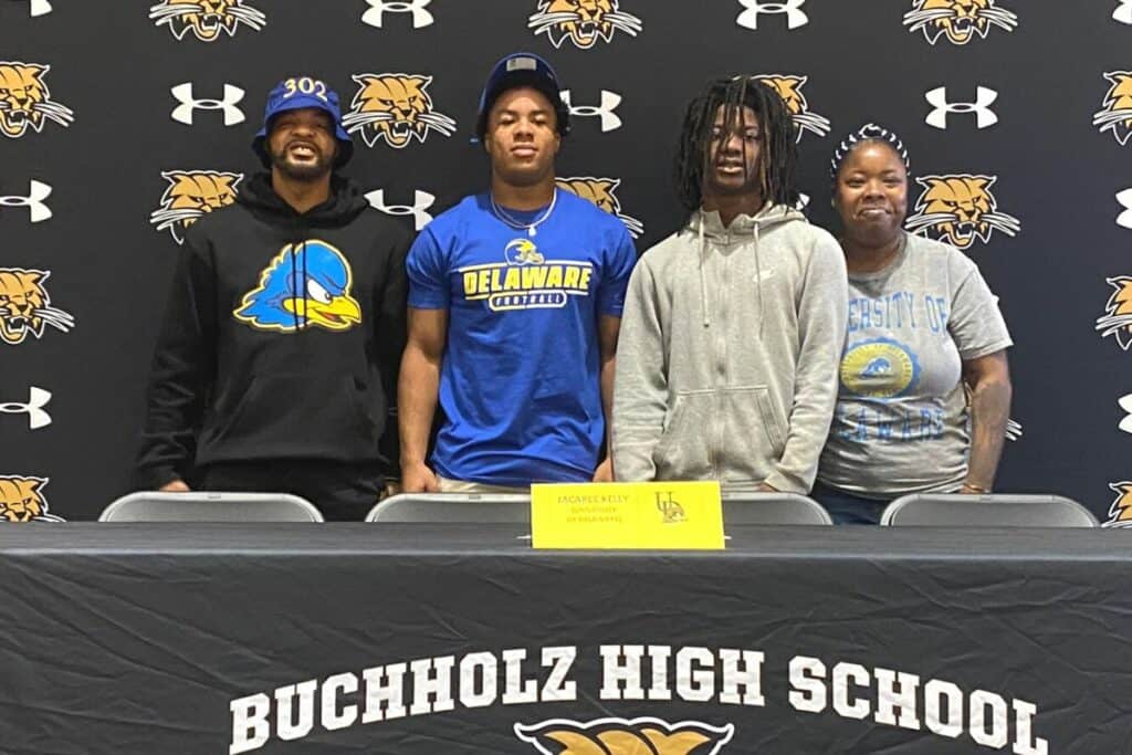 Buchholz's Jacarree Kelly (second from left) committed to play football at Delaware on Tuesday