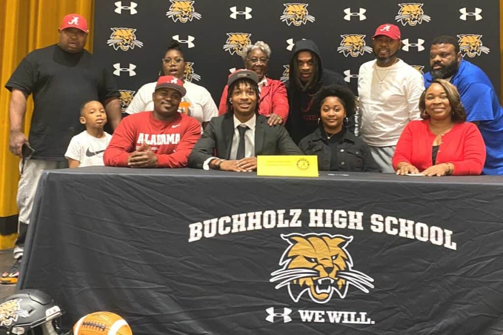 Buchholz's Jaren Hamilton (front row in tie) committed to play football at Alabama on Tuesday