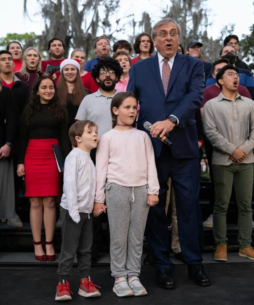 Children from the audience help UF President Ken Fuchs count down to the lighting of the holiday gator.