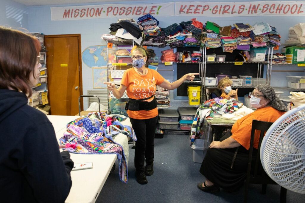 Event organizer Radha Selvester organizes her crew of volunteers before the work begins.