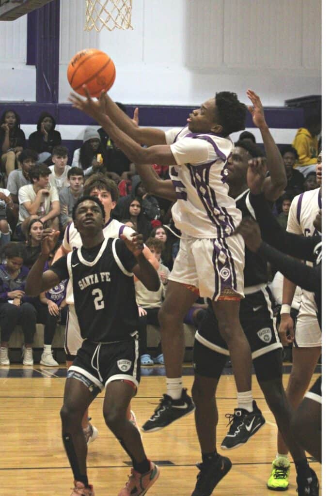 Gainesville's Elijah Williams goes for a rebound against Santa Fe on Thursday.