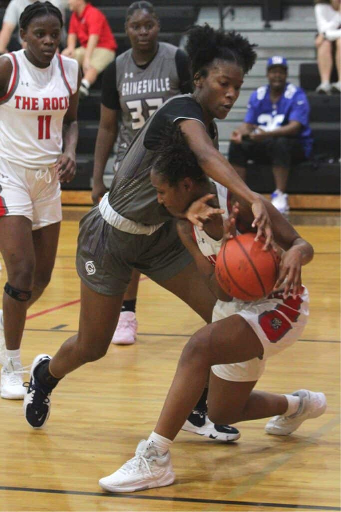 Gainesville's Leyah Houston battles The Rock's Reeyona Johnson for a loose ball on Tuesday.