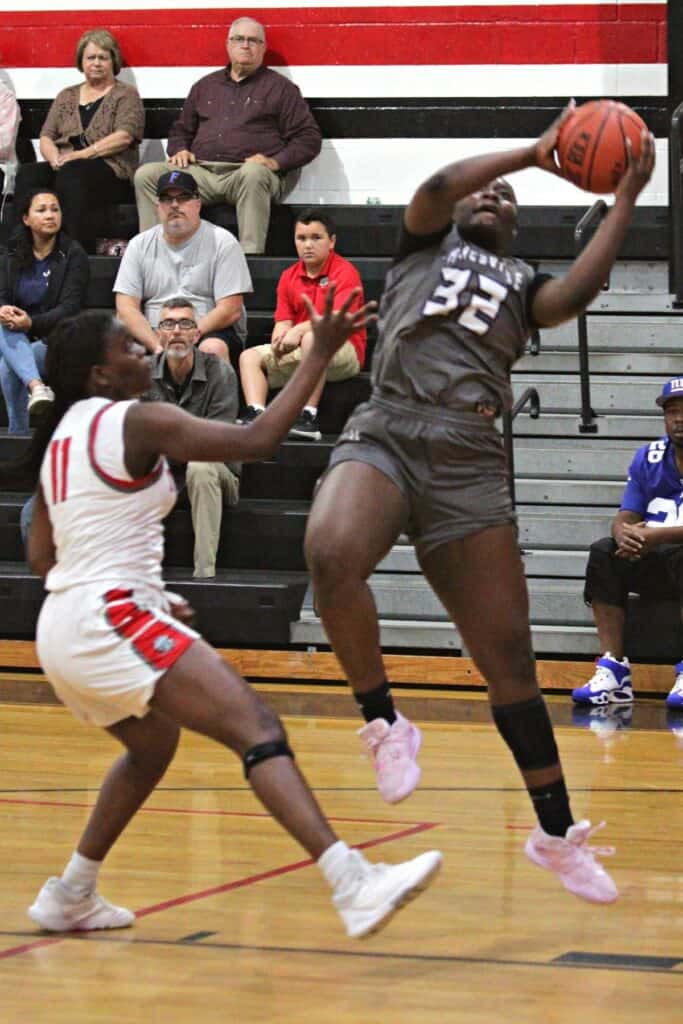 Gainesville's Ta'Niyah Walker with rebound against The Rock on Tuesday.