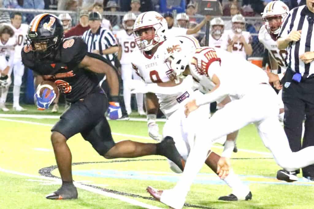 Hawthorne's Isaiah Donaldson busts through for a first down on the Hornets' final offensive drive against Northview on Saturday.