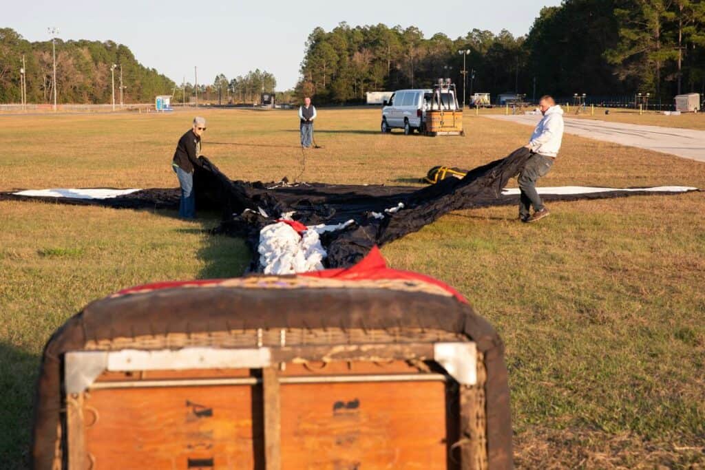 Nita Dillbeck, from left, Nita's husband Ricky Dillbeck and Brian Chase of Cartoon Balloons of Orlando unfold a Slyvester the cat balloon before the start of the festival.