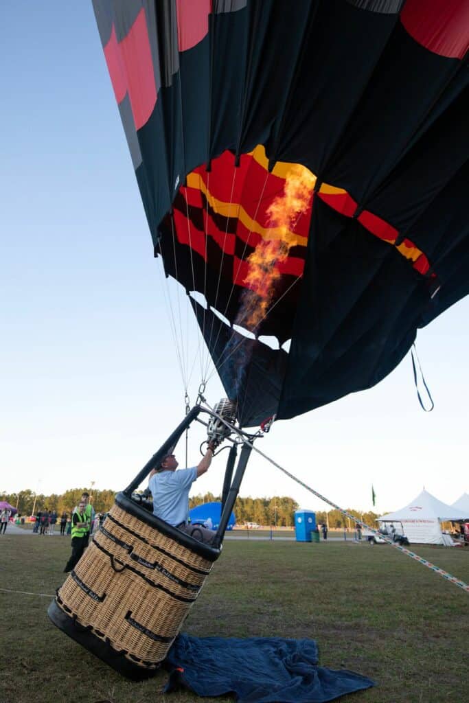 Patrick Fogue, a balloon pilot from Missouri, blows propane into his balloon to right it.