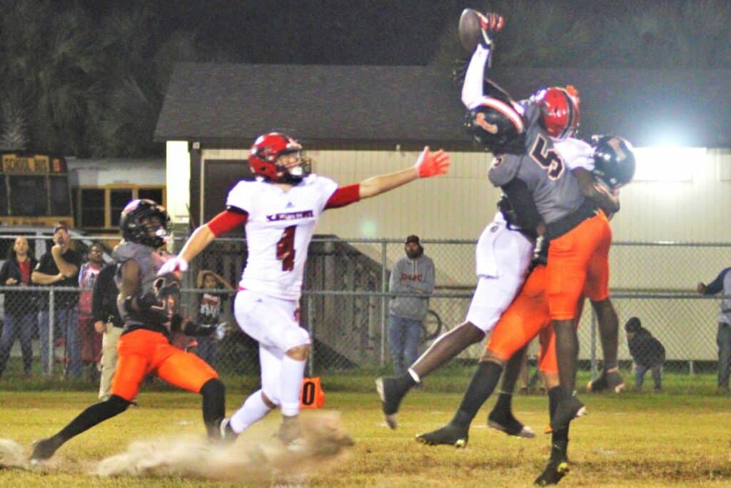 Two Hawthorne defenders break up a long pass against Blountstown on Friday.