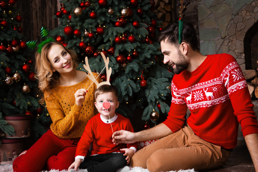 Family in front of Christmas tree