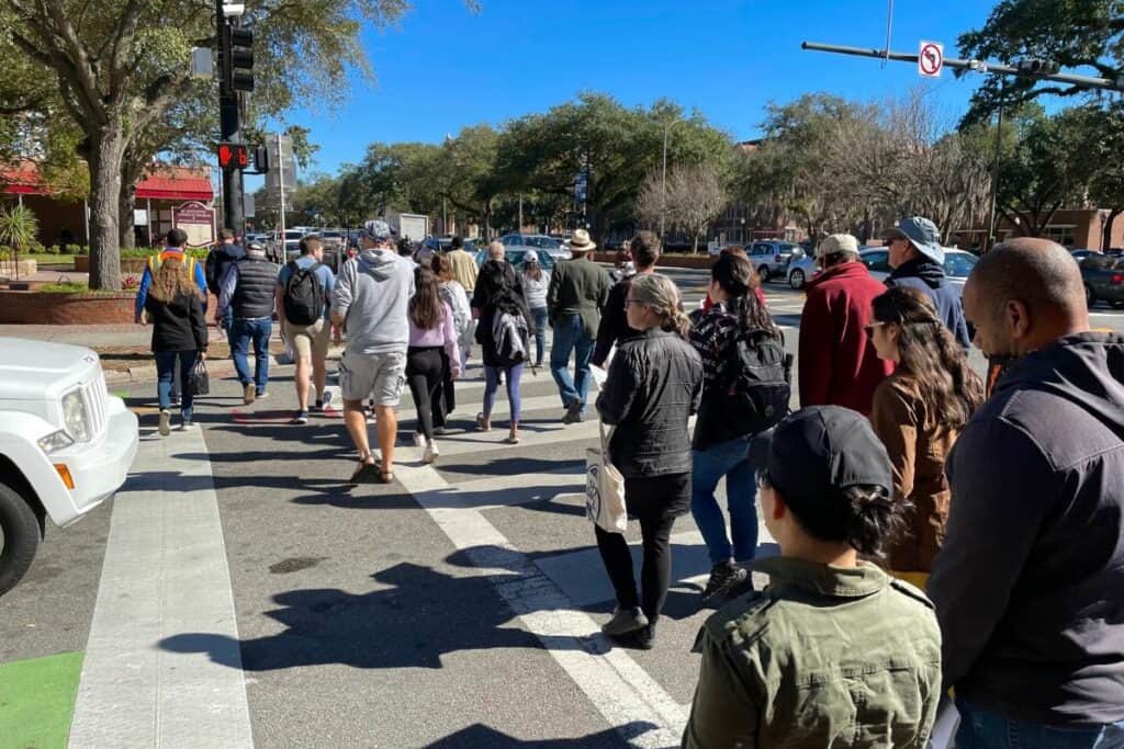 A Corridor Walk group crosses the road.
