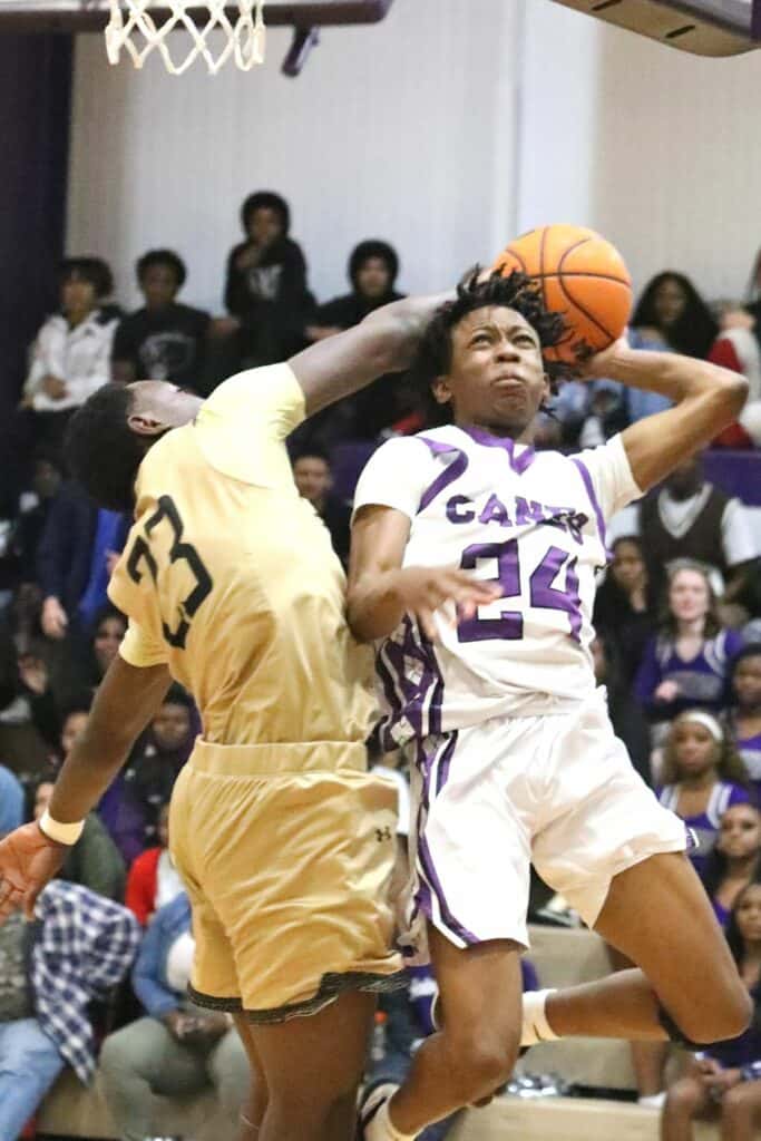 Buchholz's Collin Dunmore blocks Dacarion Debose's second-half shot on Friday.