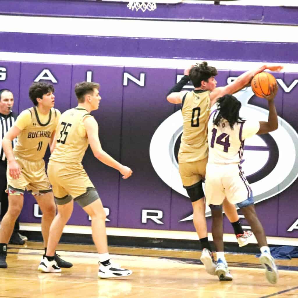Buchholz's Jacob Sterck (0) attempts to block Gainesville's SJ Westbrook's shot on Friday.