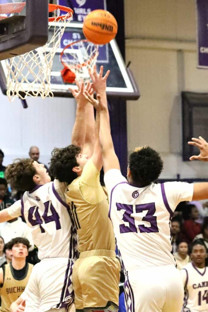 Buchholz's Nate Muchnick (11) battles for a rebound against Gainesville's Anthony Leivonen (44) and Josh Hayes (33) on Friday.