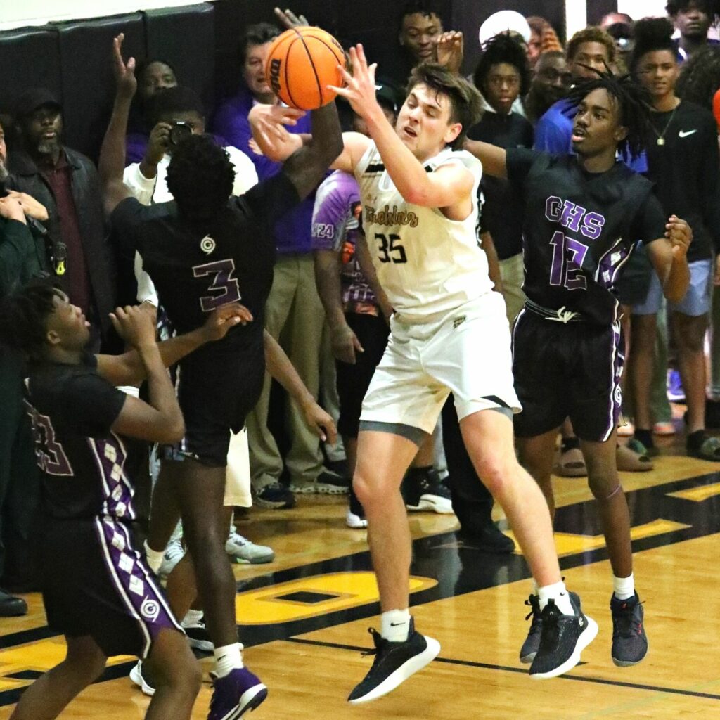 Buchholz's Palmer Walton (35) battles Gainesville's Theo Stephens (3) for a rebound on Friday.