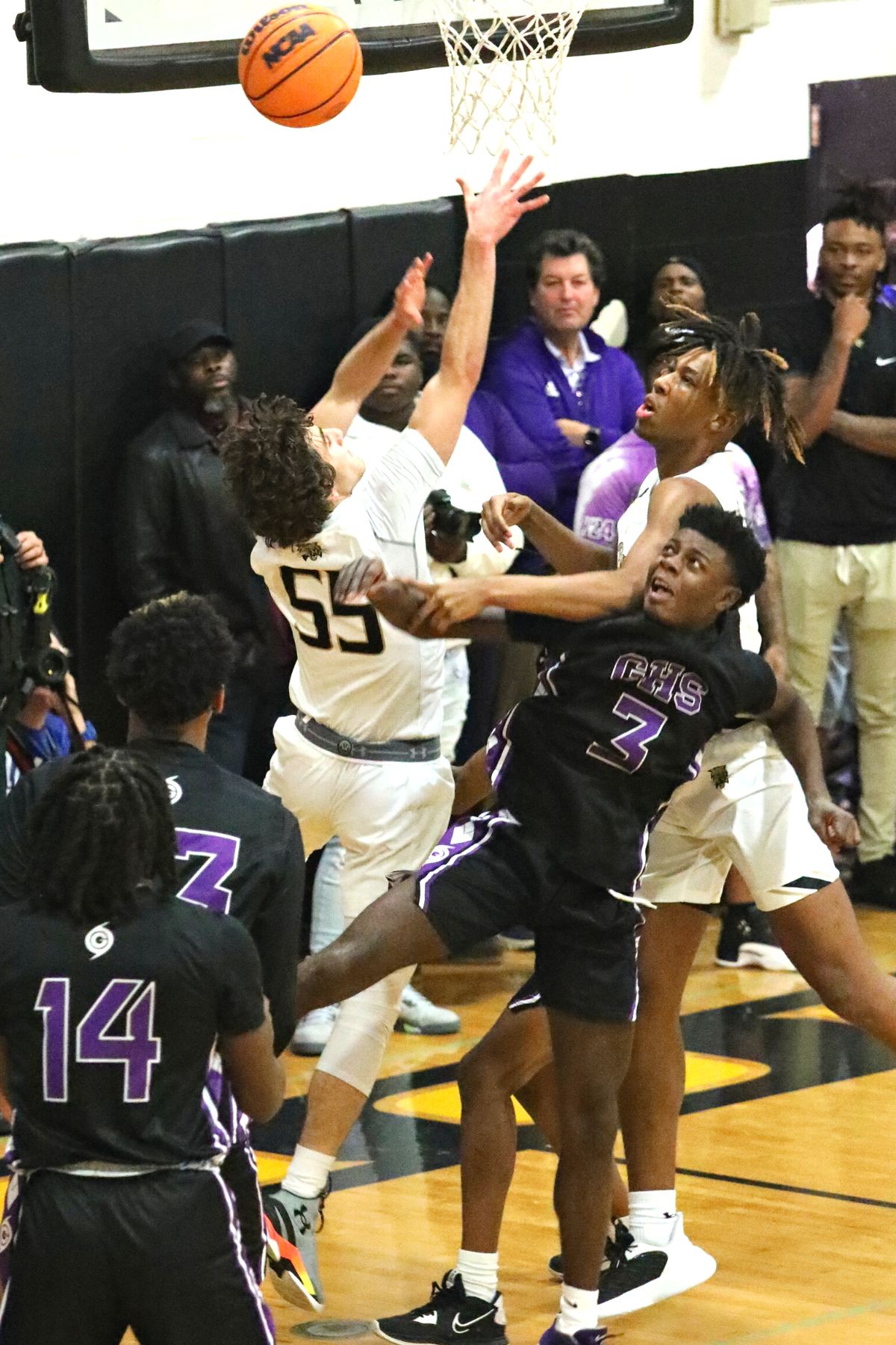 Buchholz's Ryan Webster (55) and Cornelius White battle Gainesville's Theo Stephens (3) for a rebound on Friday.