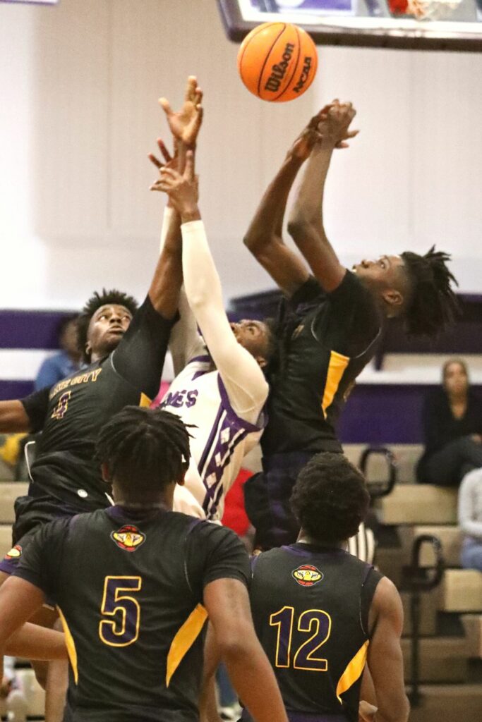 Columbia's Ty'jahn Wright (4) and D'Maceo Sheppard battle Gainesville's for a rebound on Tuesday.