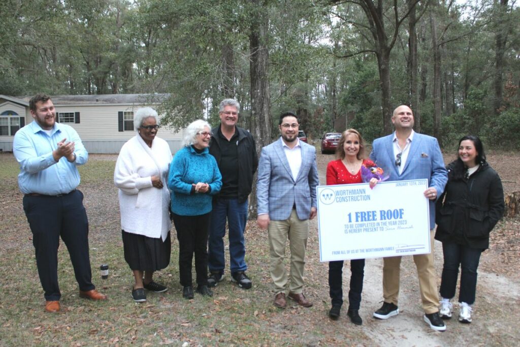 Community and Worthmann Construction officials with free roof giveaway winner Sara Hannah (red shirt) at Friday's event.