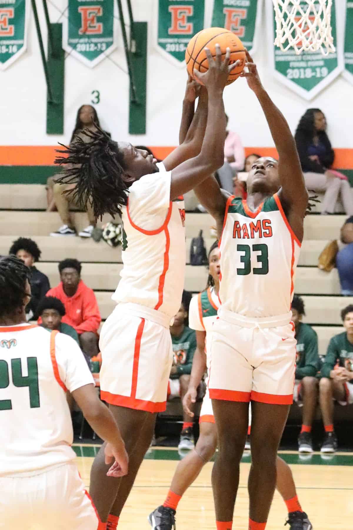 Eastside's Shelton Hall and Davion Pugh (33) go afer a rebound against North Marion on Friday.