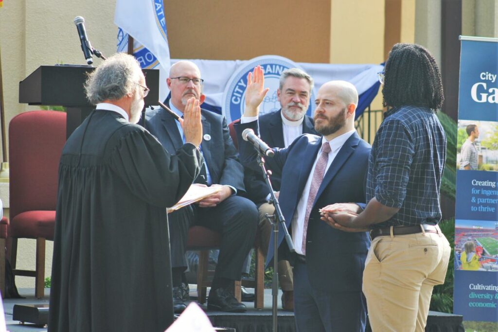 Gainesville City Commissioner Casey Willits takes his oath of office.