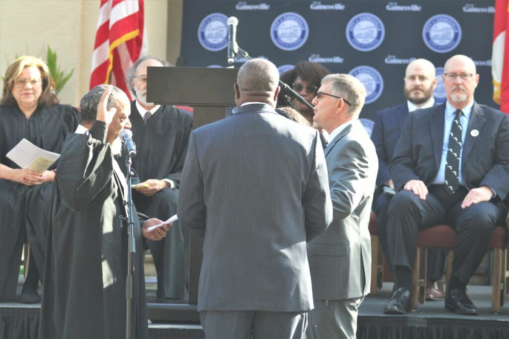 Gainesville City Commissioner Ed Book recites his oath of office.