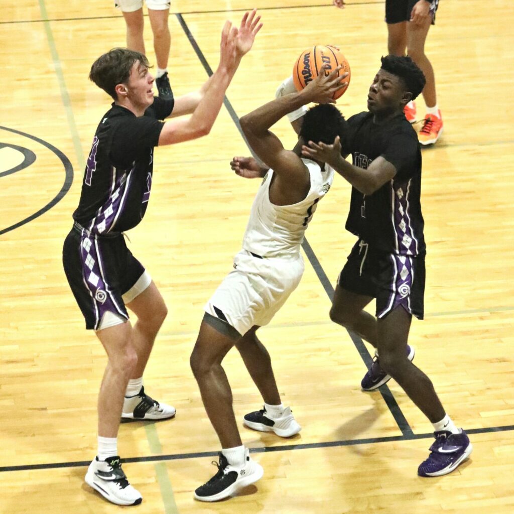 Gainesville's Anthony Leivonen (left) and Theo Stephens defends against Buchholz's Tyler Gainey on Friday.