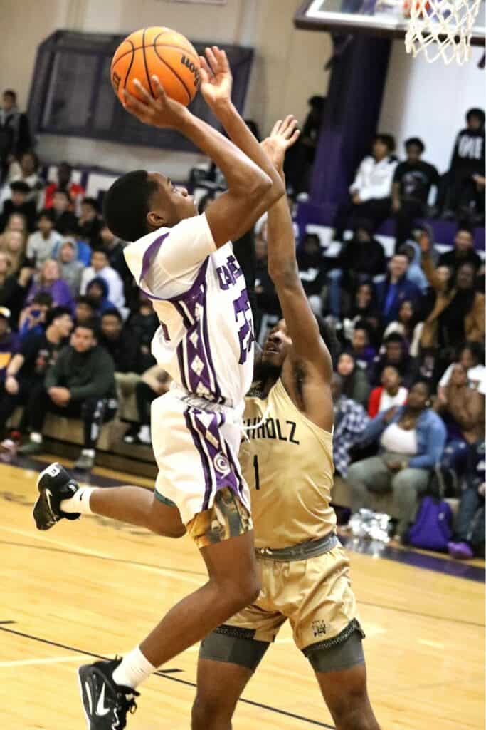 Gainesville's Elijah Williams (22) with a third-quarter steal and basket against Buchholz's Tyler Gainey (1) on Friday.