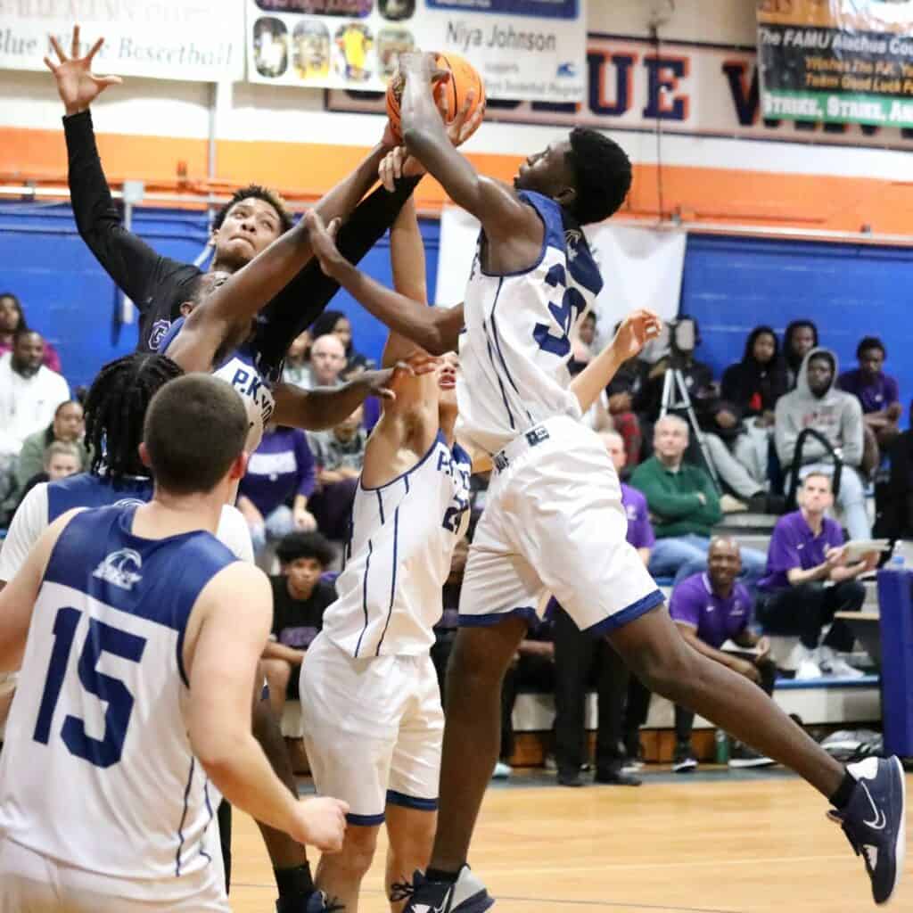 Gainesville's Josh Hayes and P.K. Yonge's Randall Robinson, Moses Horne and Isaiah Cooper battle for a rebound on Tuesday.