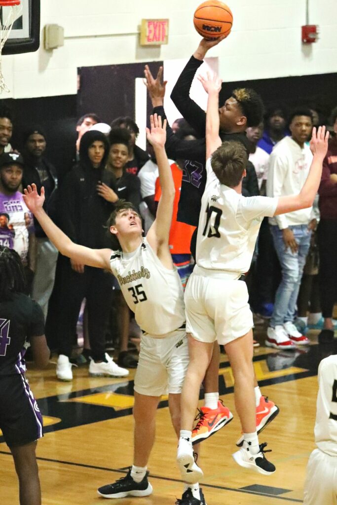 Gainesville's Josh Hayes with a shot against Buchholz's Palmer Walton (35) and Gabe Thompson (10) on Friday.