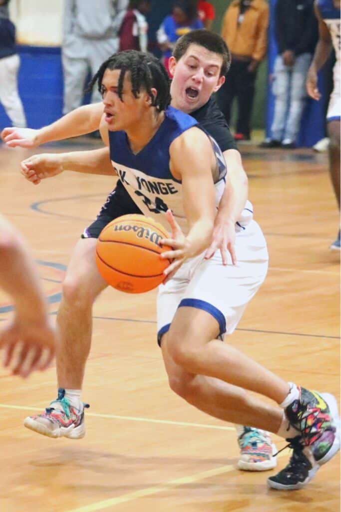 Gainesville's Seth Childers attempts to knock the ball loose against P.K. Yonge's Moses Horne on Tuesday.
