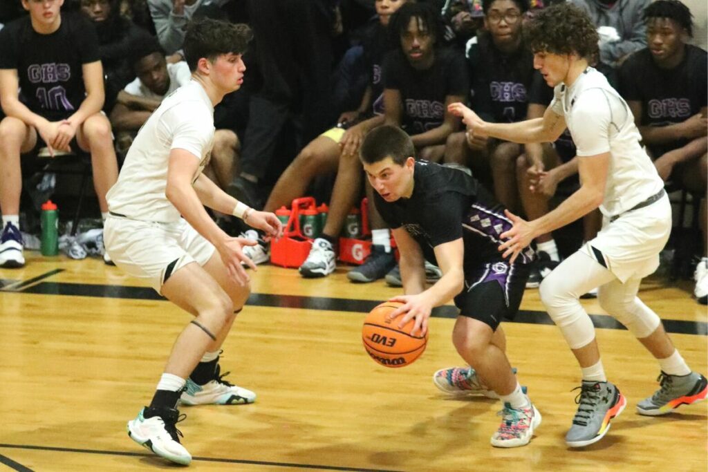 Gainesville's Seth Childers dribbles between Buchholz's Jacob Sterck (left) and Ryan Webster on Friday.