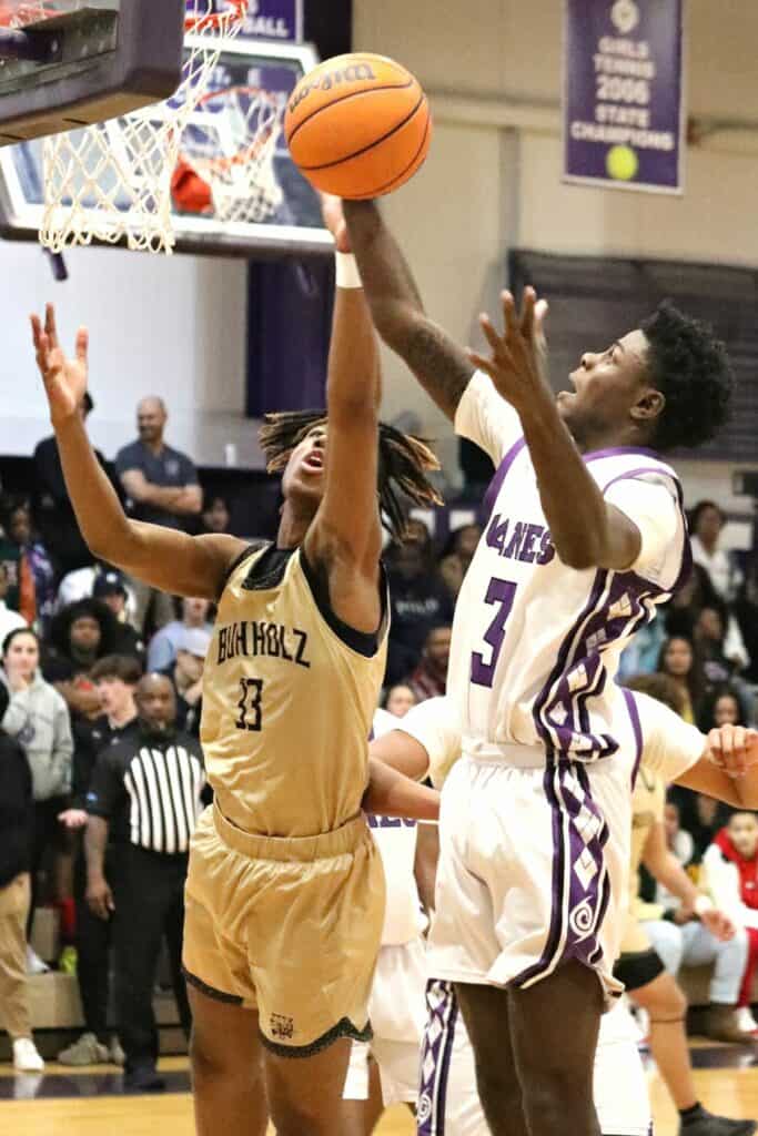 Gainesville's Theo Stephens (3) grabs a first-half rebound against Buchholz's Cornelius White (33) on Friday.