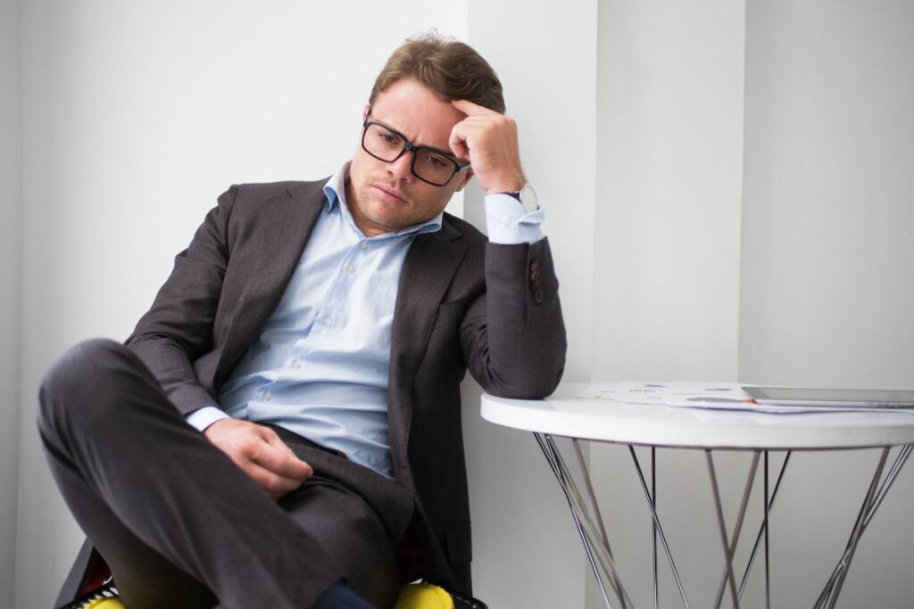 Man deep in thought sitting at a table