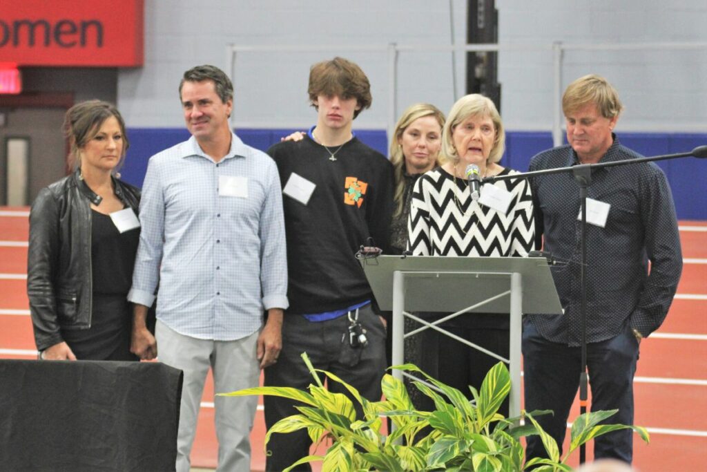 Nanette Carnes, with her family, speaks about her husband at Saturday's dedication.