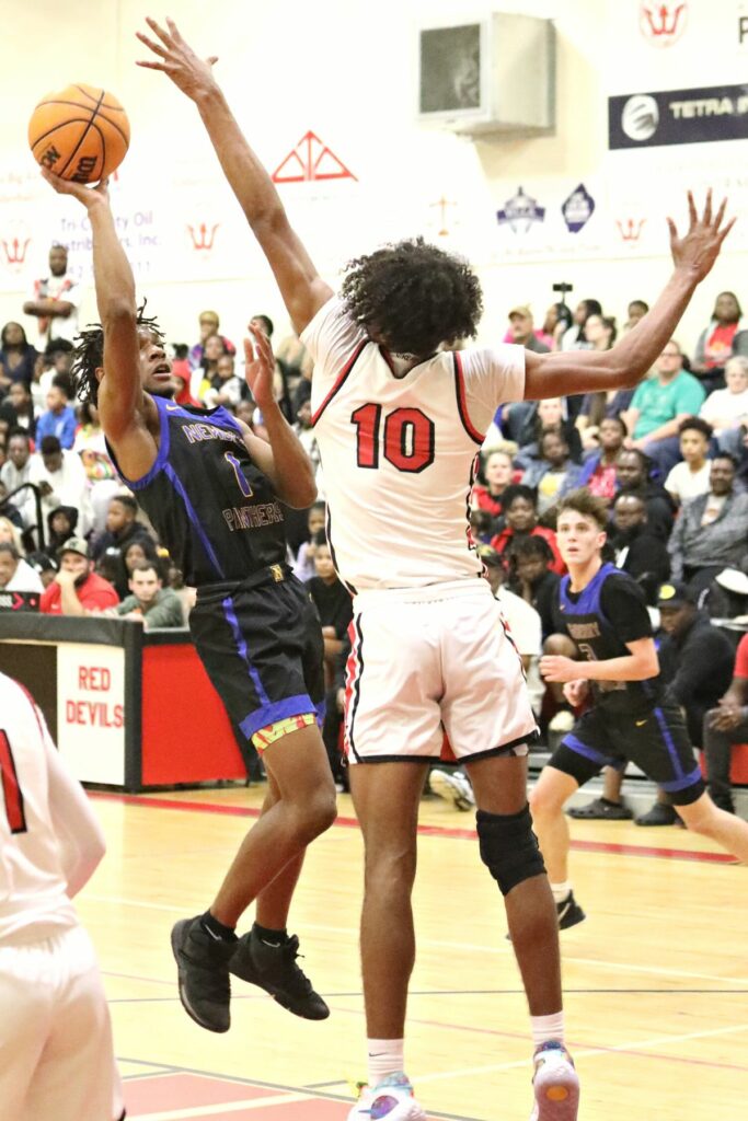 Newberry's Mike Moore (1) attempts a shot against Williston's Kyler Lamb (10) on Friday.