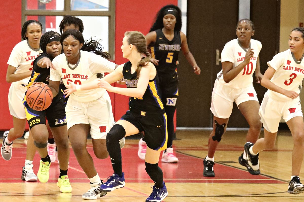 Newberry's Sarah Beaulieu (left) and Evalyn Guild (right) go for the ball against Williston's Acacia Haynes on Friday.