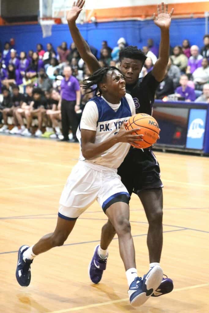 Gainesville's Seth Childers attempts to knock the ball loose against P.K. Yonge's Moses Horne on Tuesday.