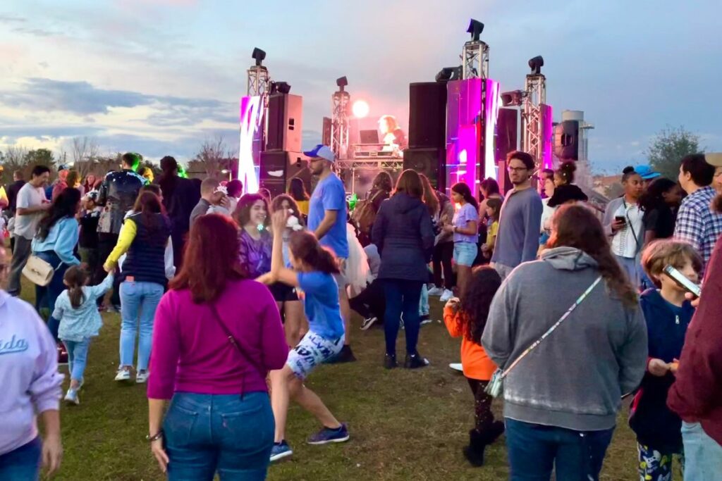 People dance on the hill during Sparks in the Park.