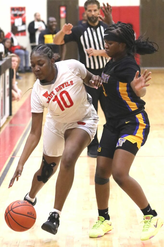 Williston's Tia Coleman (10) defended by Newberry's Sarah Beaulieu on Friday.