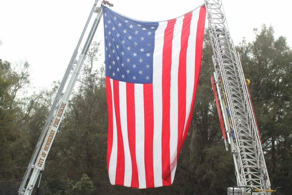 A U.S. flag was hoisted for Alachua County Sheriff's deputy Nikolas Tilliman on Friday in Newberry.