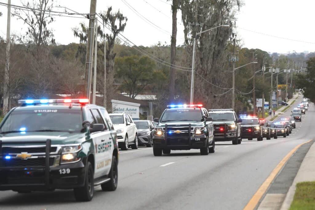 A long line of area law enforcement vehicles escorted Alachua County Sheriffs deputy Nickolas Tilliman on Friday afternoon.