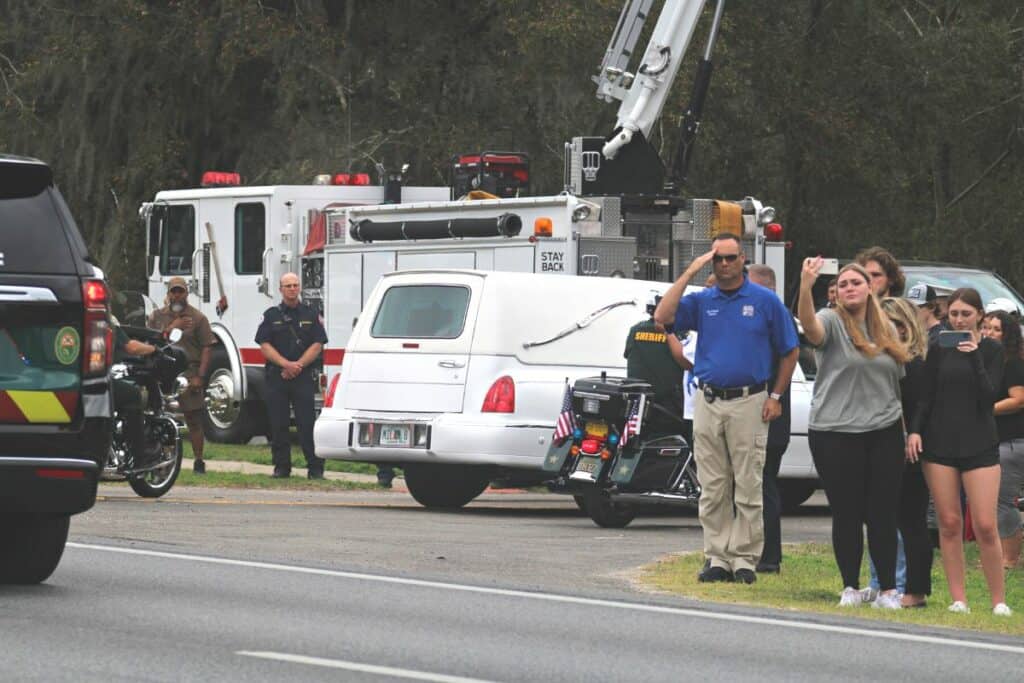 Alachua County Sheriff's deputy Nickolas Tilliman was honored by the community as his hearse pulled into Milam Funeral Home in Newberry on Friday.