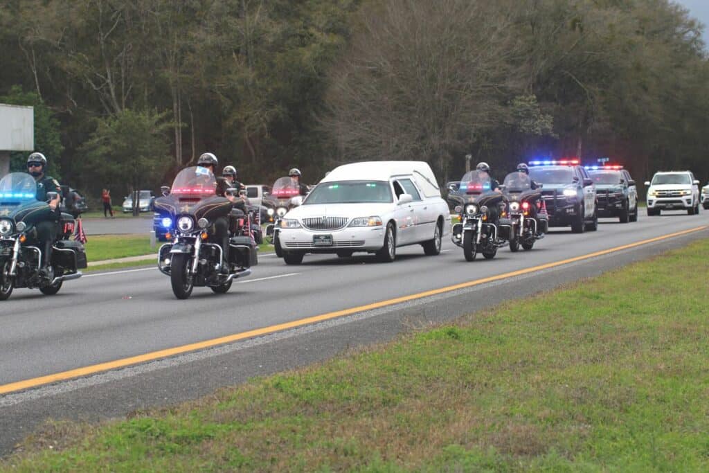 Alachua County Sheriff's deputy Nikolas Tilliman's hearse as it arrived at the Milam Funeral Home in Newberry on Friday.