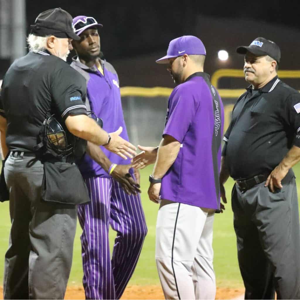 First year coaches Jiwan James (Union County) and Adrian Ramos (Gainesville) shake hands prior to Thursday's game in Lake Butler.