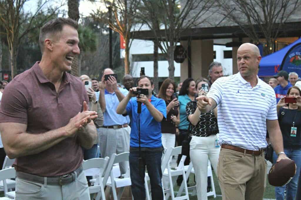Former UF football players Chris Doering (left) and Danny Wuerffel reenacting a past college play at the Steve Spurrier Way road naming celebration on Friday.