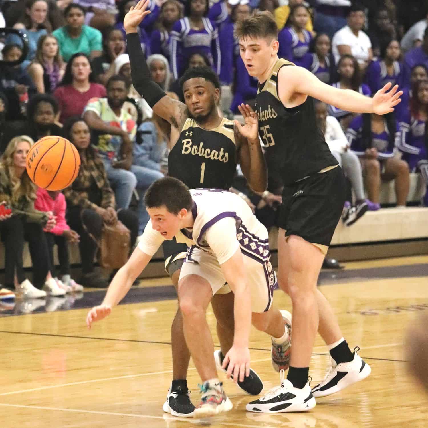 Gainesville's Seth Childers sandwiched between Buchholz defenders Tyler Gainey (1) and Palmer Walton (35) late in the fourth quarter in the District 6A-2 championship game on Friday.