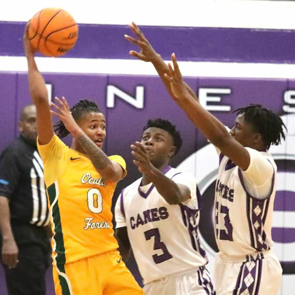 Gainesville's Theo Stephens (3) and Jordan Bowie (23) defend against Forest's Xzavion Mccoy in the Region 1-6A quarterfinals on Thursday.