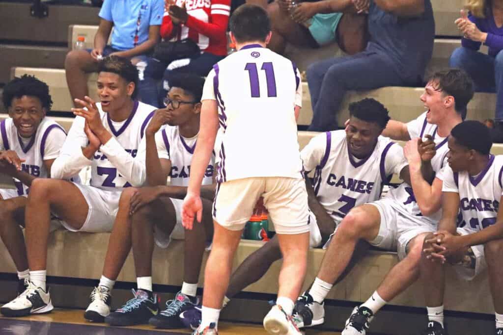 Gainesville's Theo Stephens (third from right) celebrates with teammates after it was announced that he scored his 1,000th career point as a Hurricane on Thursday in a win over Forest.