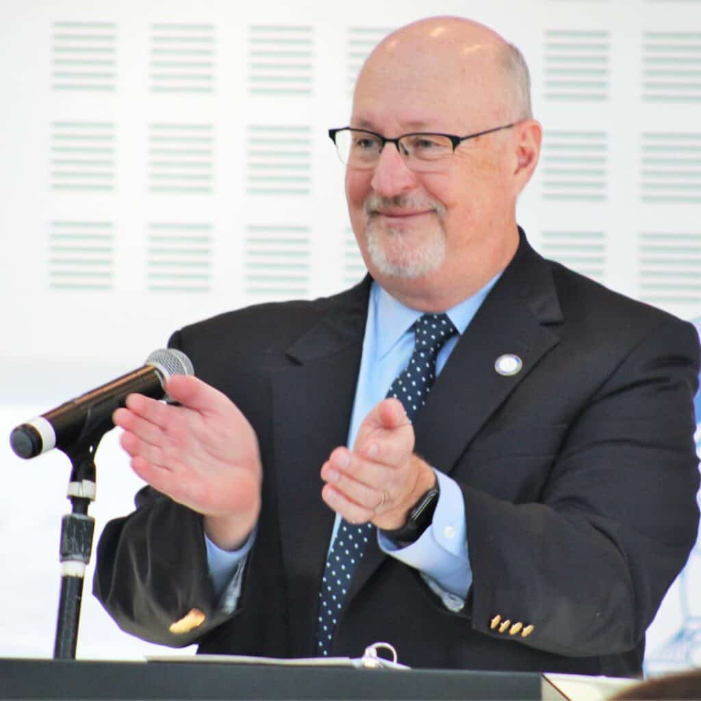 Mayor Harvey Ward applauds for a GPD officer recognized at Tuesday's State of the City event.